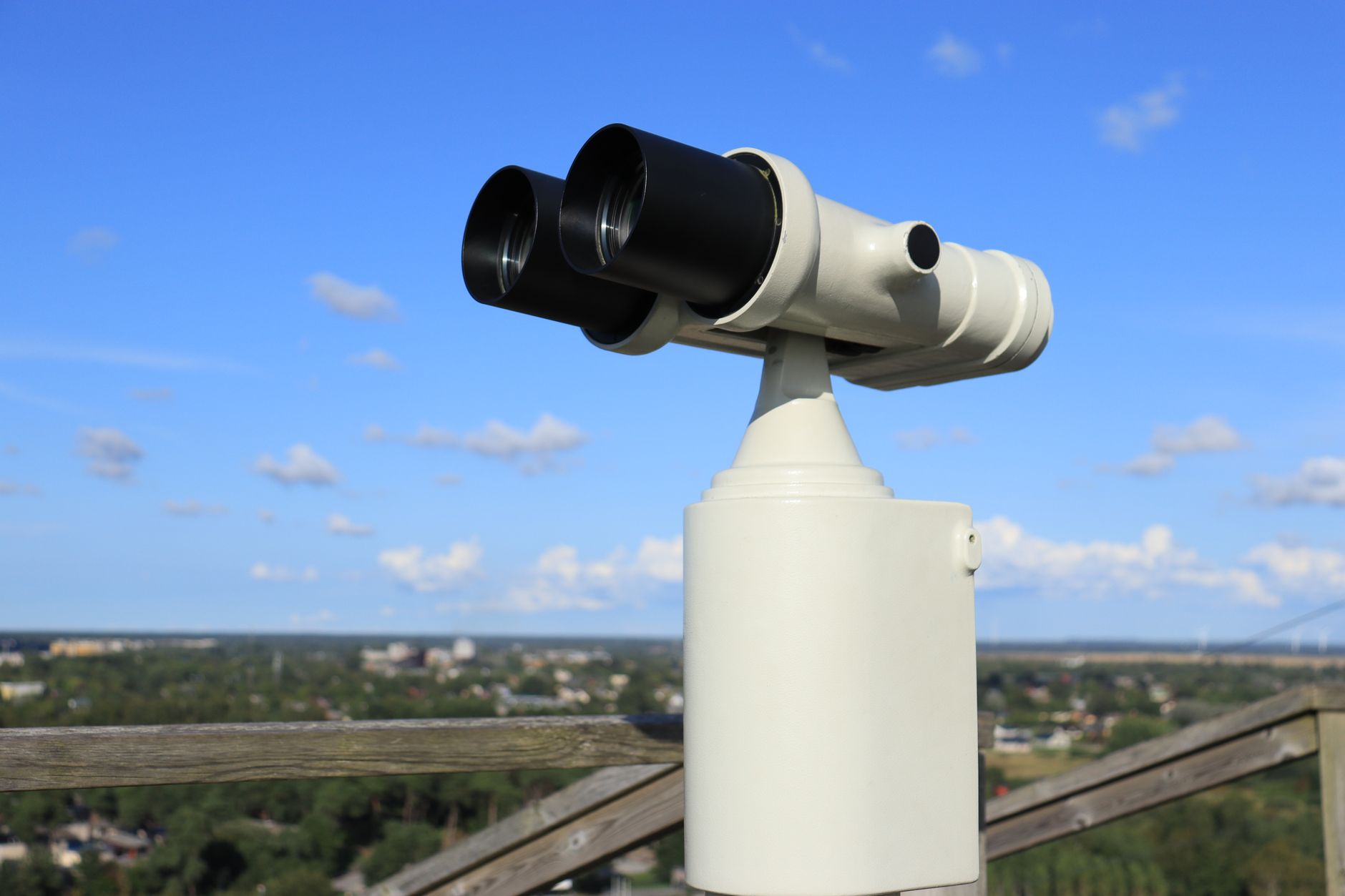A public telescope offering a stunning daytime view of the city skyline.